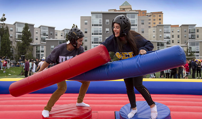students in a play pin with inflatable objects competing 