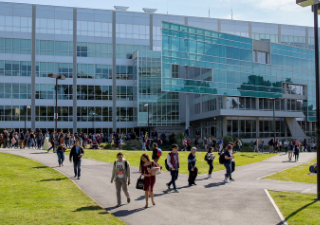 Photo of the SFSU Library with students walking outside
