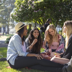 students sitting at the University quad talking and laughing