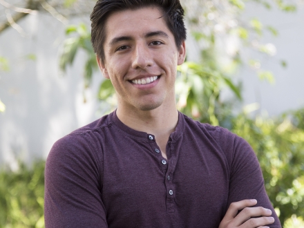 Student photograph with arms crossed smiling at the camera