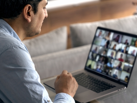 a man looking at a zoom call on his computer