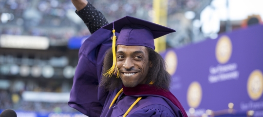 student celebrating graduation