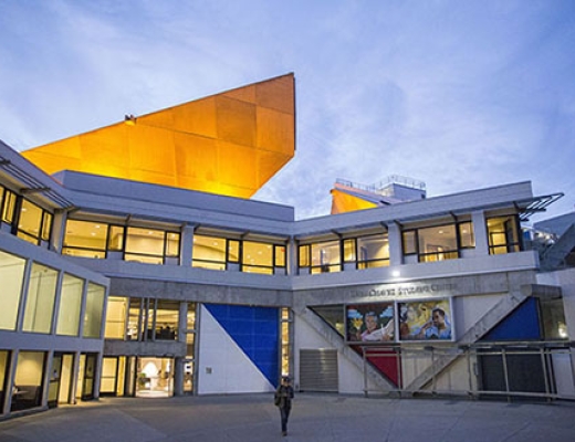 The outside of the Cesar Chavez Student Center at night